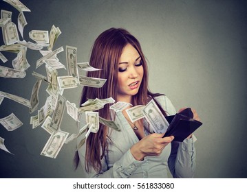 Sad Woman Looking At Her Wallet With Money Dollar Banknotes Flying Out Away 