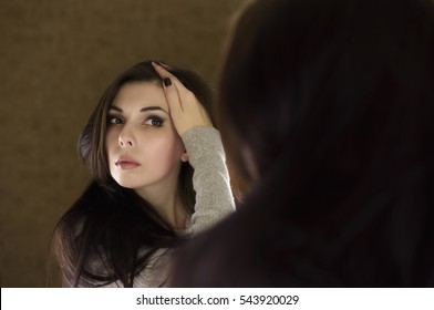 Sad Woman Looking In The Mirror