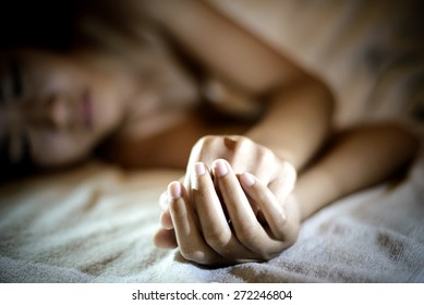 Sad woman is lying in bed at night , dark feeling