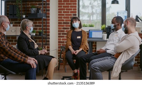 Sad Woman Making Confession In Front Of People At Aa Therapy Session During Pandemic. Desperate Adult With Face Mask Crying At Rehabiliation Program Meeting With Psychologist.