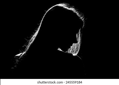 sad woman profile silhouette in dark, monochrome image