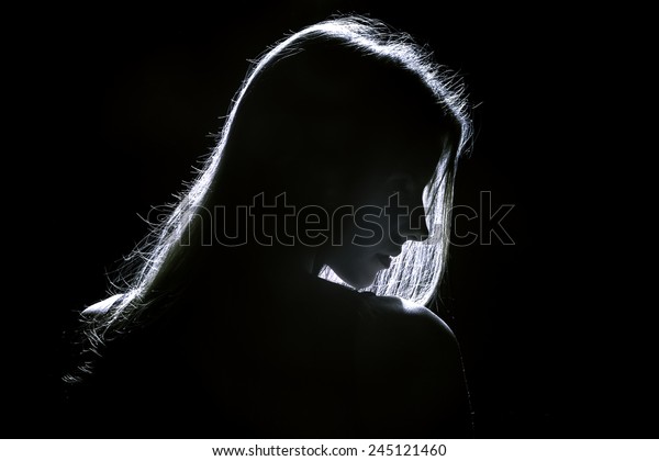 sad woman profile
silhouette in dark