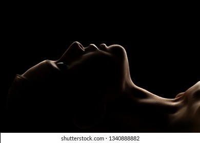 sad woman profile silhouette on black background closed eyes
