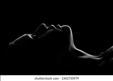sad woman profile silhouette on black background closed eyes, monochrome