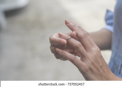 Sad Woman Removing Wedding Ring.