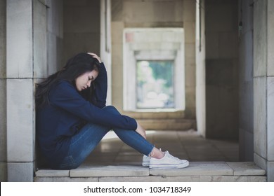 Sad woman sitting alone, Concept of sadness, melancholy
