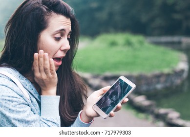 Sad Woman Sitting On The Bench With Cracked Phone