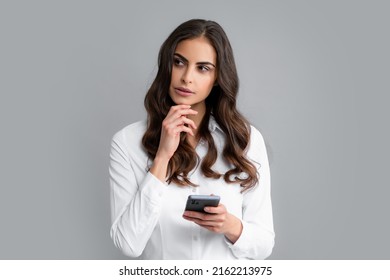 Sad Woman With Smart Phone. Young Woman With Mobile Phone. Serious Business Woman With Smartphone On Grey Background.