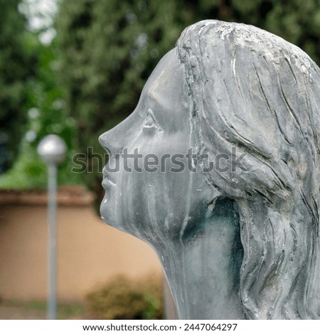 Sad woman statue. Praying woman statue. Shallow dof.