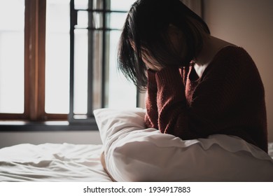 sad woman suffering depression insomnia awake and sit alone on the bed in bedroom. sexual harassment and violence against women, health concept