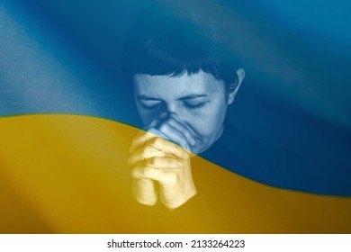 Sad woman with Ukraine flag at background praying. Concept of standing with Ukrainian nation in war with Russia. - Shutterstock ID 2133264223
