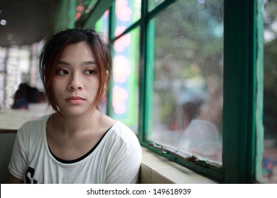 Sad woman waiting someone who is late, after cry,she look outside nearby window,  reflection on glasses in restaurant of Hong Kong - Shutterstock ID 149618939