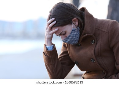 Sad Woman Wearing Mask Complaining Sitting On A Bench On The Beach In Covid Days