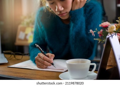 Sad Woman Writing And Noted In Calendar Book. Hand Of Planner Mark Schedule On Diary At Business Office Desk.Work From Home Concept.