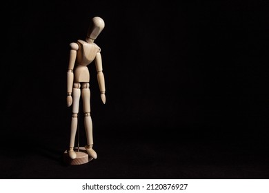 Sad wooden mannequin with his head lowered. Symbol of depression and breakdown - Powered by Shutterstock