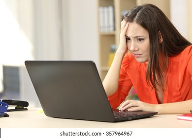 Sad and worried entrepreneur working on line with a laptop in an office desk or home - Shutterstock ID 357964967