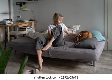 Sad Worried Middle-aged Woman Sitting On Sofa Caring For Old Sick Pet At Home, Saying Goodbye Before Death, Spend Final Day Together, Upset Female Pet Owner Petting Ill Dog Curl Up In Ball In Bed