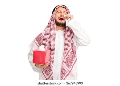 Sad young Arab crying and wiping his tears with wipes isolated on white background