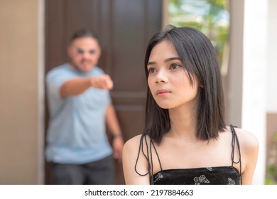 A Sad Young Asian Woman Is Being Scolded By Her Father Early In The Morning. Listening To Verbal Abuse From A Furious Parent.