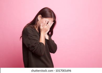 Sad Young Asian  Woman Cry With Palm To Face On Pink Background