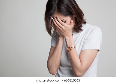 Sad Young Asian  Woman Cry With Palm To Face On Gray Background