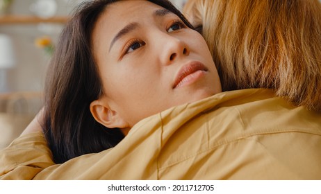 Sad Young Asian Woman Hug Cuddle Embracing With Best Friend In Living Room At Home Support Each Other With Hard Time With Feel Sick And Bad, Relationship Support Concept.