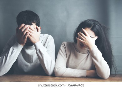 sad young couple sitting in table on dark background - Shutterstock ID 756447463