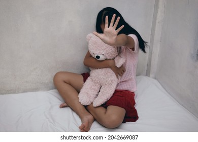 Sad young girl sitting in bed room.The concept of sexual harassment against women and rape, stop violence against Women,sexual abuse, 