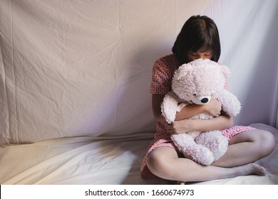 Sad Young Girl Sitting In Room. Human Trafficking Concept.