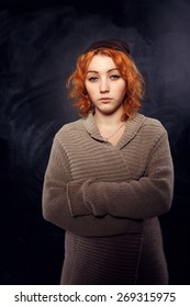 Sad Young Girl. Woman No Smiles. Close Up Portrait Of An Attractive Young Woman Laughing With Hair Blowing. The Woman Is Not Smiling. Young Red-haired Girl With Very Serious Expression On His Face.