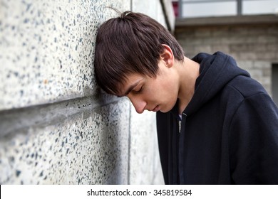 Sad Young Man By The Wall Outdoor