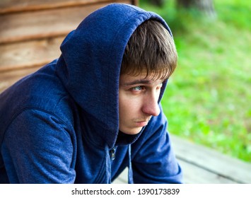 Sad Young Man in a Hoodie on the Street - Powered by Shutterstock