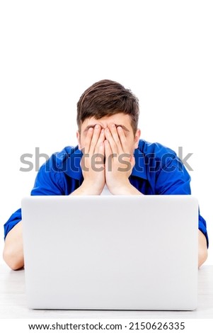 Sad Young Man with Laptop cover his Face with a Hands Isolated on the White Background