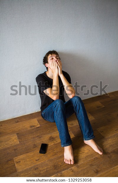 Sad Young Man On Floor Room Stock Photo (Edit Now) 1329253058