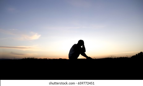 A Sad Young Man Silhouette Worried At Sunset