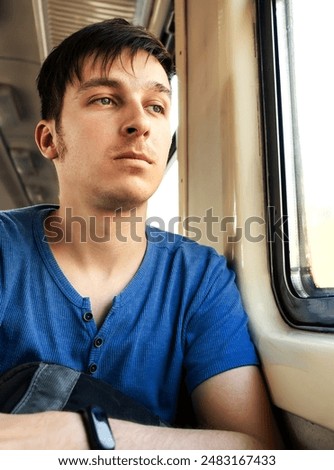 Sad Young Man sit in the Train by the Window