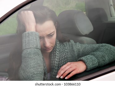 Sad Young Woman In The Car