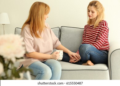 Sad Young Woman And Her Mother At Home