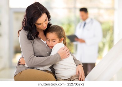 sad young woman and her sick daughter waiting for checkup in doctor's room - Powered by Shutterstock