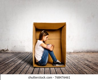 Sad Young Woman Inside A Box On A Room