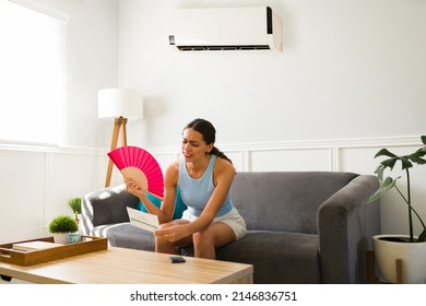 Sad Young Woman Looking At The Expensive Electricity Bill And Deciding Not To Use The Ac Unit 