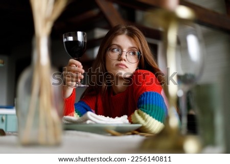 Sad young woman on a date in a restaurant, quarrel in a relationship.
