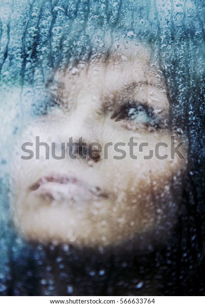 Sad young woman and a rain
drops