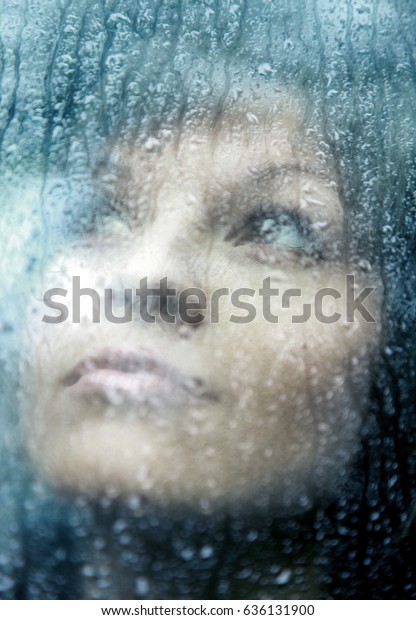 Sad young woman and a rain\
drops