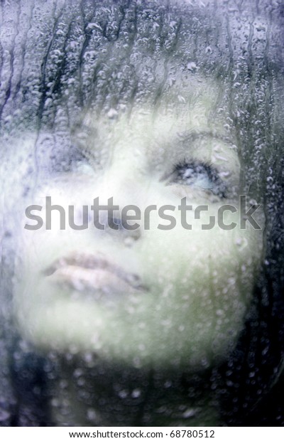 Sad young woman and a rain\
drops