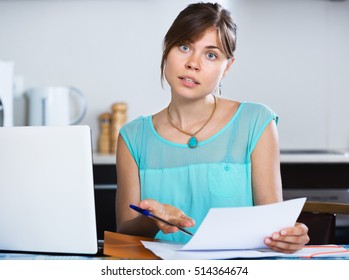 Sad Young Woman Reading Banking Statement