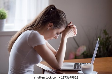 Sad young woman sit at laptop broken after reading bad news online, upset girlfriend hurt receive breakup or split message from lover, desperate female get negative email losing hope or failure notice