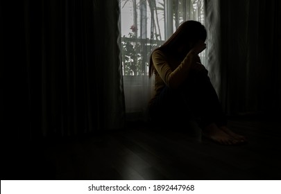 Sad young woman sitting in the bedroom, People with depression concept.