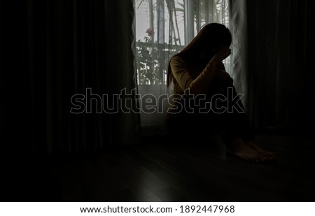 Sad young woman sitting in the bedroom, People with depression concept.