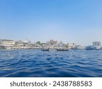 Sadarghat river view landscape, Transporting local people by small boats across the river, Commuter ferryboat in the monsoon, Boat ride in the Buriganga river.